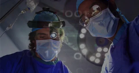 In operating room, surgeons performing surgery with data processing animation 库存影片 303842059