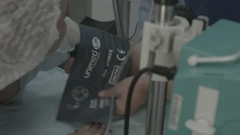 Operating room, team of surgeons prepares patient to cancer removal surgery via Video stock 143160254