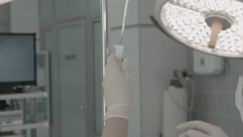 Operating room, team of surgeons prepares patient to cancer removal surgery via Video stock 143160314