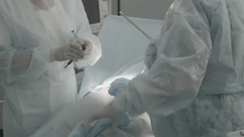 Operating room, team of surgeons prepares patient to cancer removal surgery via Video stock 143160316