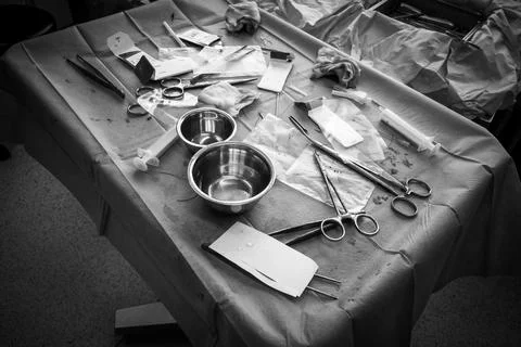 In an operating room there is a used operating table with instruments Stock Photos