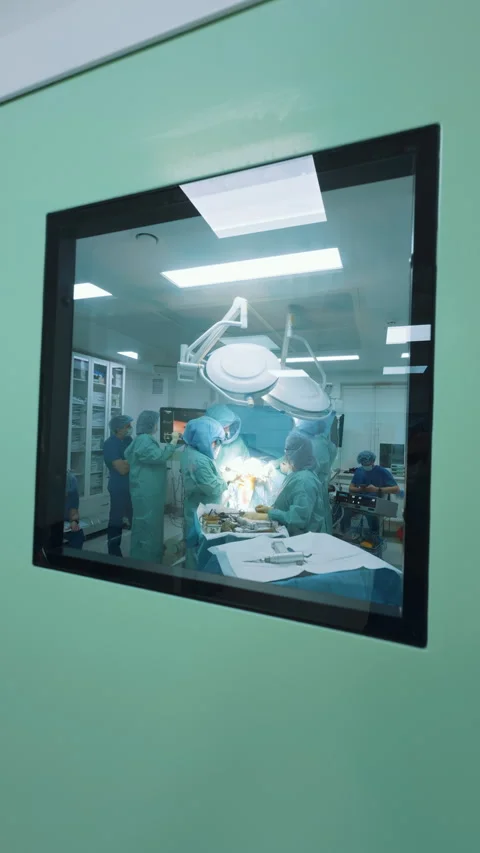 Operating room view through a small square window Stock Footage 322566502