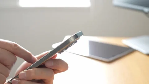 Operating a Smartphone at a Bright Home Office Desk Stock-Footage 330174762