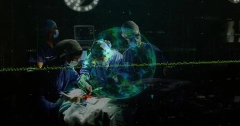 Operating surgical team performing surgery in dim OR, with instruments and Stock Photos