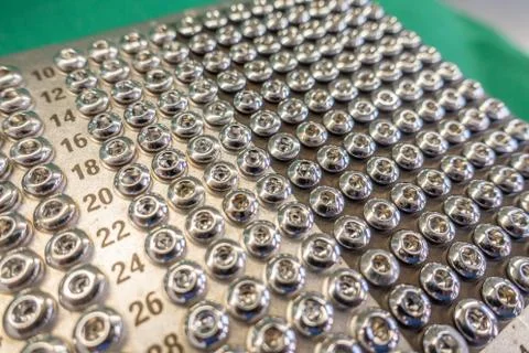 On  operating table is a tray with various surgical steel screws Stock Photos