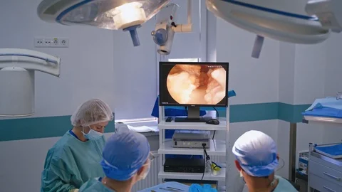 Operating theatre with video camera technology. Medical surgical team performing Video stock 120980969