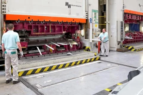 Operating workers on hydraulic press Stock Photos