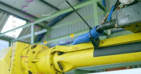 Operating yellow robotic arm rotating joint flange in factory, blue hose, gauge Stock Photos