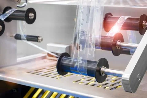 The operation of automatic plastic bag production machine. Close-up of the ro Foto stock