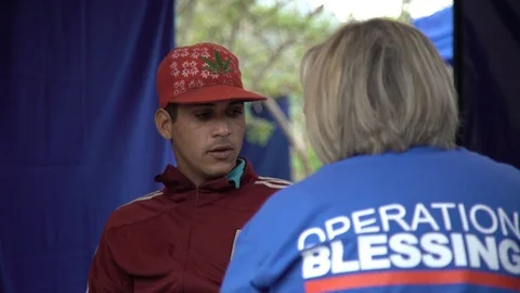 Operation Blessing volunteer interviews migrant Stock Footage 108548271