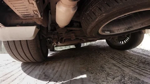The operation of the car suspension in motion. Camera on the bottom of the car Stock Footage 278861294