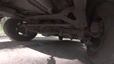 The operation of the car suspension in motion. Camera on the bottom of the car Stock Footage 278861333