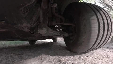 The operation of the car suspension in motion. Camera on the bottom of the car Stock Footage 278861338