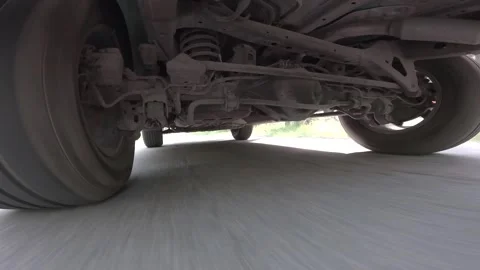 The operation of the car suspension in motion. Camera on the bottom of the car Stock Footage 278861364