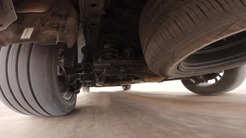 The operation of the car suspension in motion. Camera on the bottom of the car Stock Footage 292044743