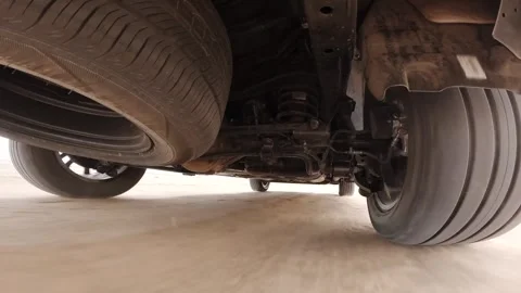The operation of the car suspension in motion. Camera on the bottom of the car Stock Footage 292044779
