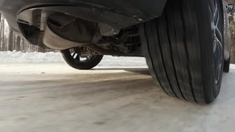 The operation of the car suspension in motion. Camera at the bottom of the car.  Stock Footage 300116479