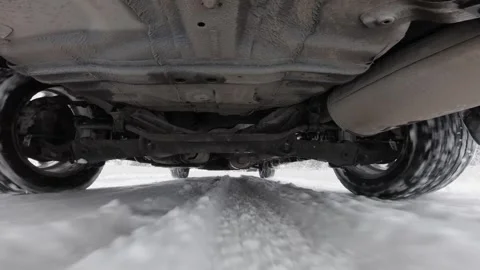 The operation of the car suspension in motion. Camera at the bottom of the car.  Stock Footage 300116531