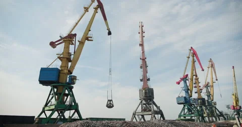 Operation of cargo cranes in the port. Unloading of cast iron. Business concept Stock Footage 197035481
