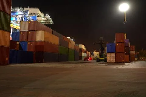 Operation of container terminal at night. Unloading container ship at night.  Stock Photos