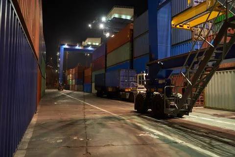 Operation of container terminal at night. Unloading container ship at night.  Stock Photos