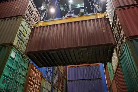 Operation of container terminal at night. Unloading container ship at night.  Stock Photos