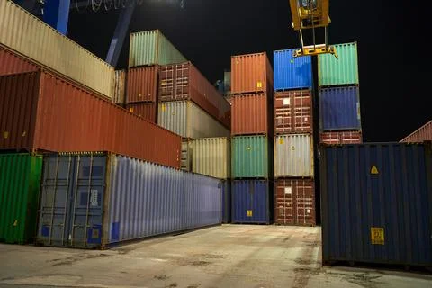 Operation of container terminal at night. Unloading container ship at night.  Stock Photos