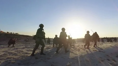 Operation Dawn Blitz - US Marines and Japanese Forces running along beach Stock Footage 81666674