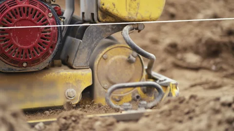 The operation of Dynamic Soil Compactors is vital in the construction site Stock Footage 312635357