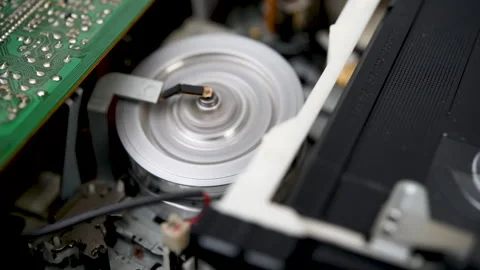 Operation of the film loading and unloading mechanism in a VCR. Video stock 305850837