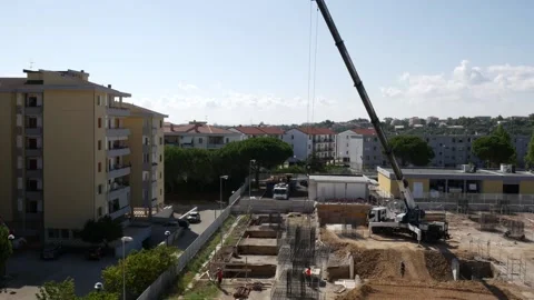 Operation of a large crane for positioning the iron structure Stock Footage 137839740