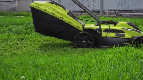 Operation of the lawn mower in the yard Stock Footage 307385339