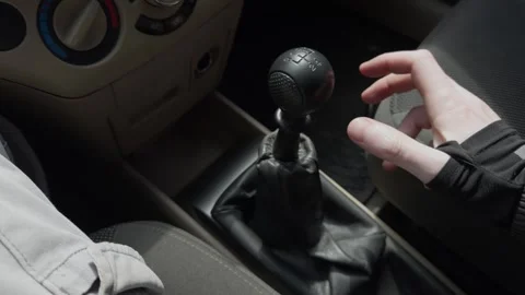 The operation of manual gear shift in a car plays a critical role in driving Stock Footage 309814513