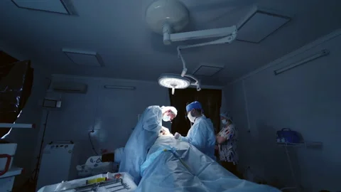 Operation in surgical room. Team of doctors conduct a surgery  Stock Footage 142365783