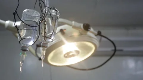 Operation table light and glucose bottle with IV drip Stock Footage 49009382