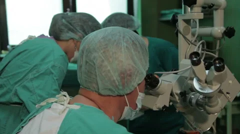 Operation of tonsils. ORL. Surgeon looking through a microscope, close up. Stock Footage 52811919