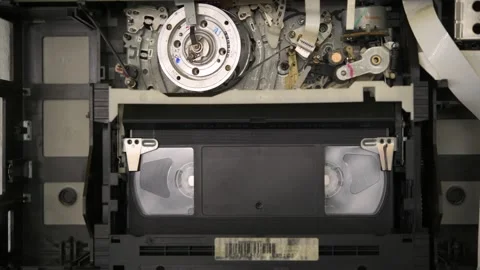 Operation of the video cassette loading mechanism in a VHS video recorder. Stock Footage 183271688