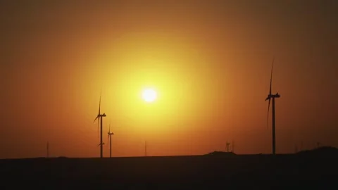 Operation of a wind power plant at sunset. Clean Energy.  Stock Footage 288194060