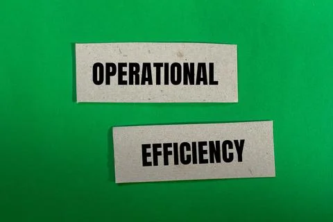 Operational efficiency message written on paper pieces with green background. Stock Photos