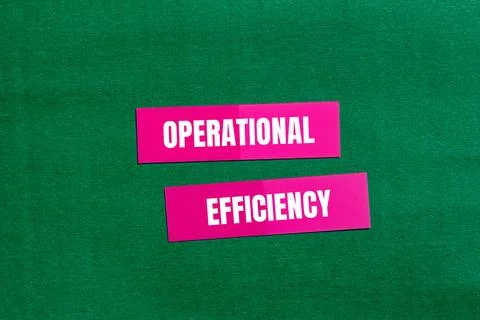Operational efficiency message written on pink paper with green background. C Stock Photos
