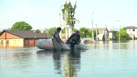 Operational services check the engine of the boat in flooded Kherson Stock Footage 244921542