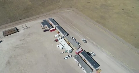 Operations buildings on a fracking pad drone flight back to reveal Stock Footage 167931318