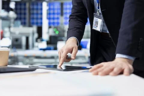 Operations employee checking performance data in a solar panel facility Stock Photos