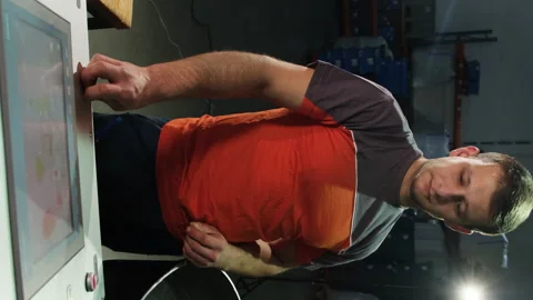 Operator activates coffee bean roasting machine using control panel Stock Footage 317095924