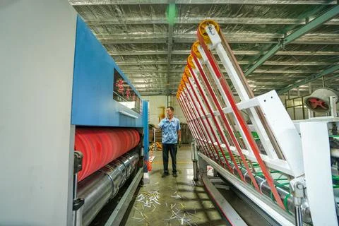 Operator Adjusting Transmission Components of Metal Rollers on Printing Unit Stock Photos