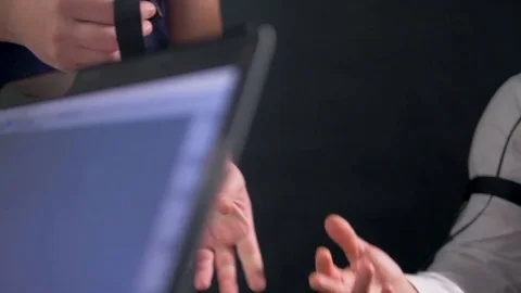 An operator attaches an electrode on a subject s finger. Stock Footage 78283680