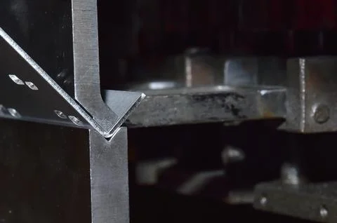 Operator bending metal sheet by sheet bending machine Stock Photos