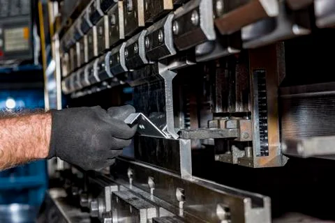 Operator bending metal sheet by sheet bending machine Stock Photos
