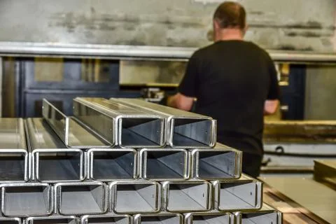 Operator bending metal sheet by sheet bending machine Stock Photos