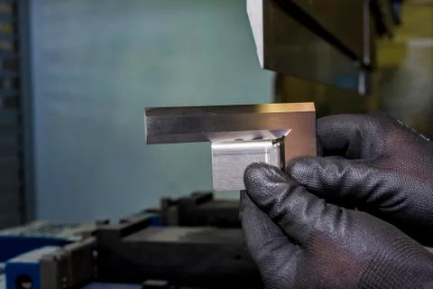 Operator bending metal sheet by sheet bending machine Stock Photos